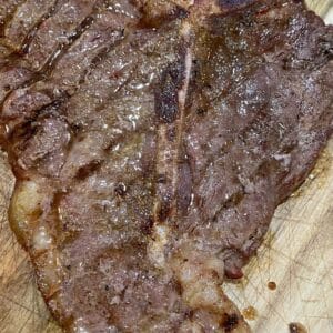 Classic grass-fed, grain-finished T-bone steak with rich marbling.