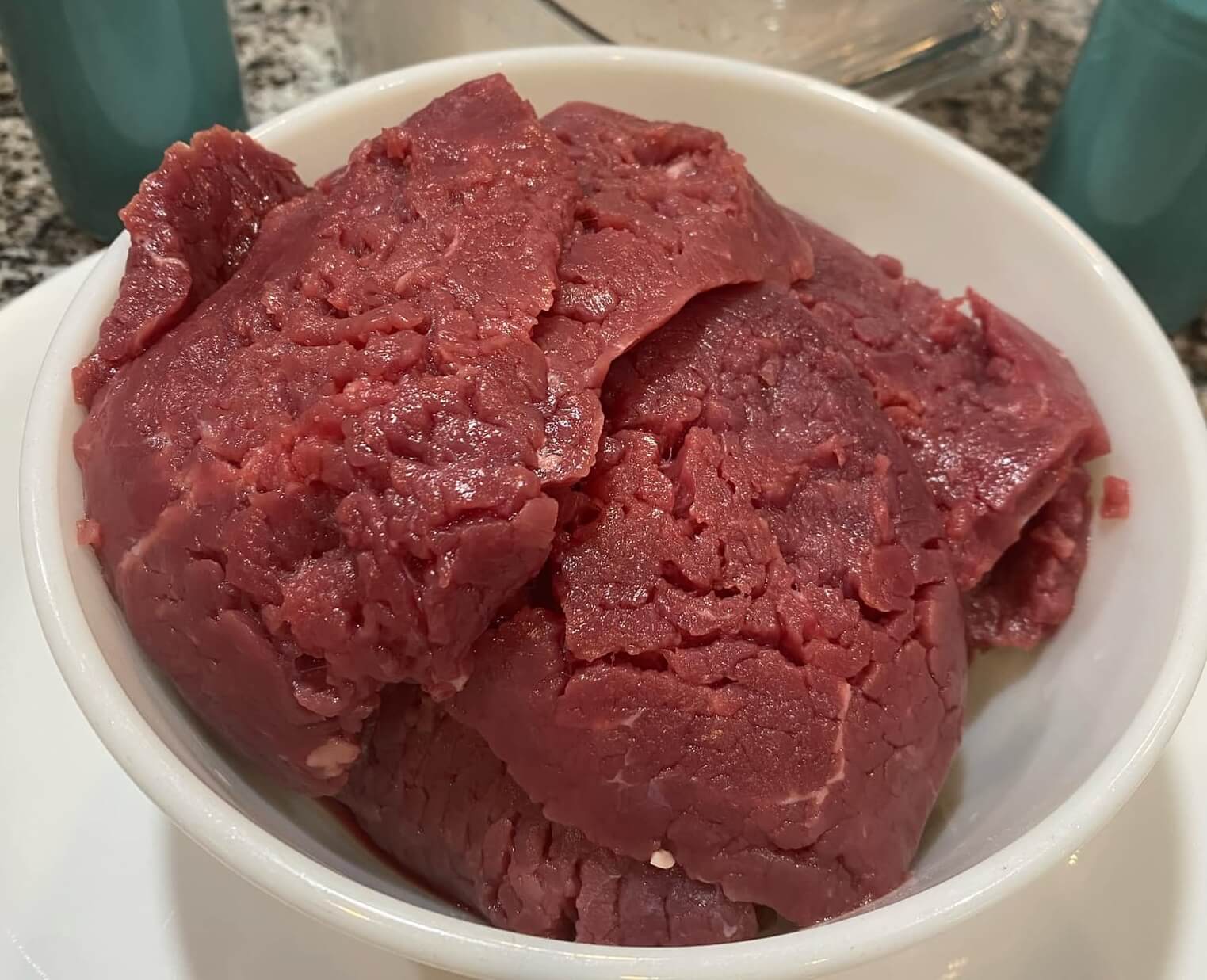 Tenderized grass-fed, grain-finished cubed steak with visible crisscross marks.