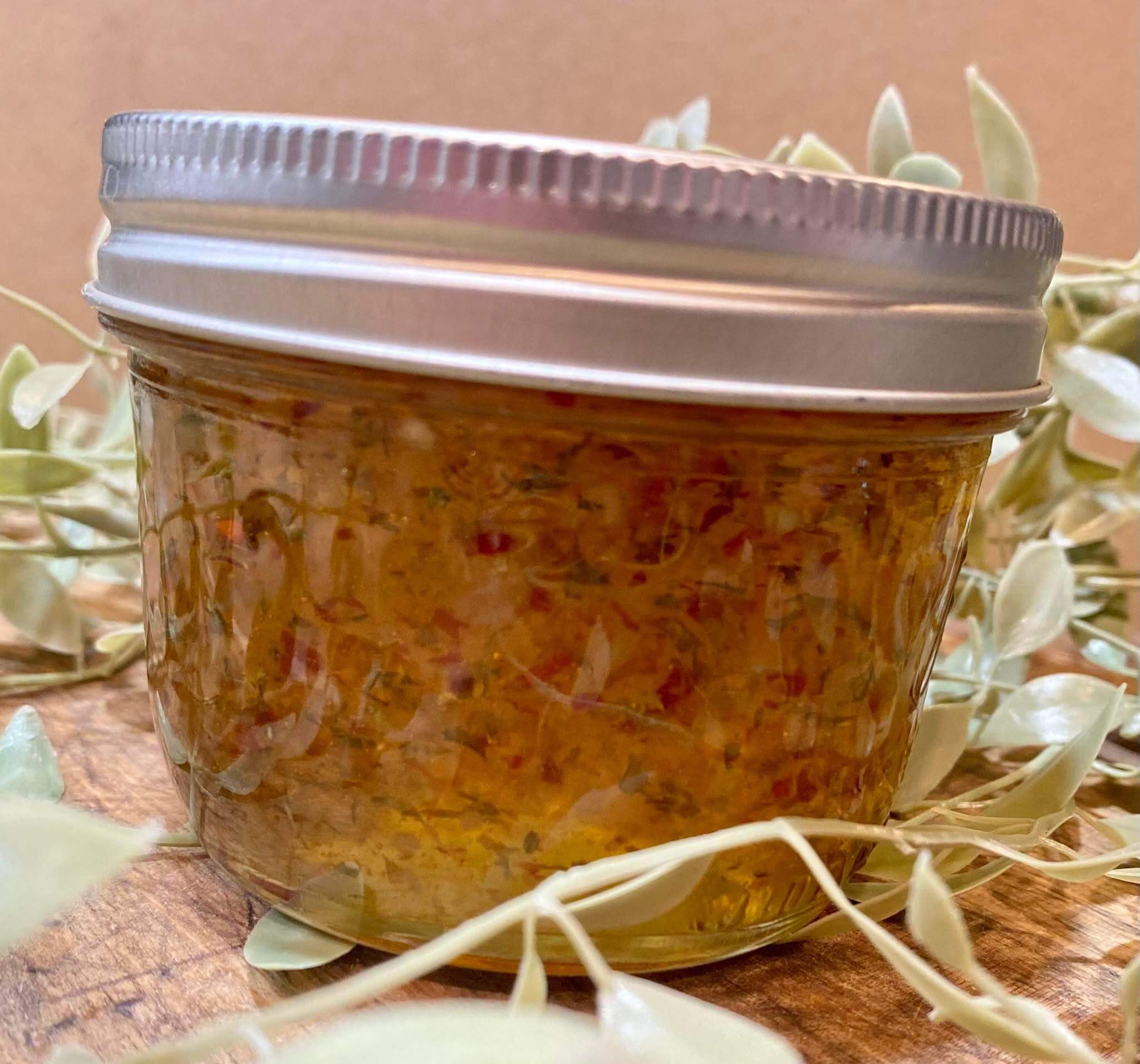 Garlic lime hot pepper jelly with a zesty, spicy flavor profile in a glass jar