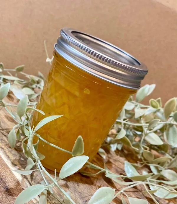 Bright and spicy pineapple habanero jelly in a handcrafted jar