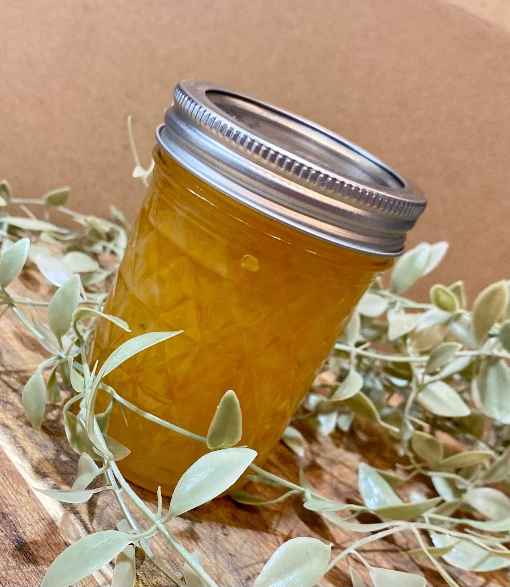Bright and spicy pineapple habanero jelly in a handcrafted jar